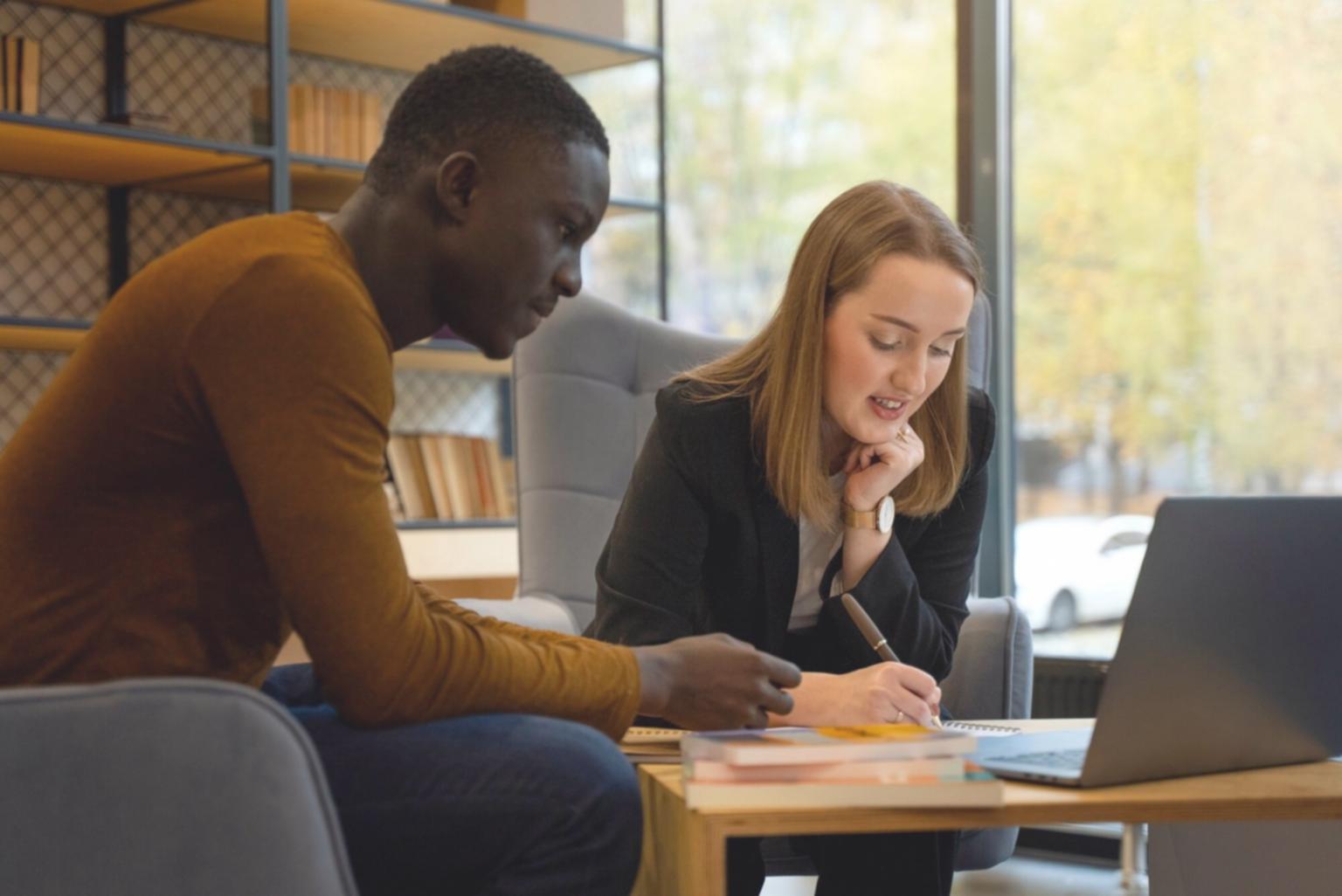 Famille discutant de finances autour d'une table avec des documents et un ordinateur portable